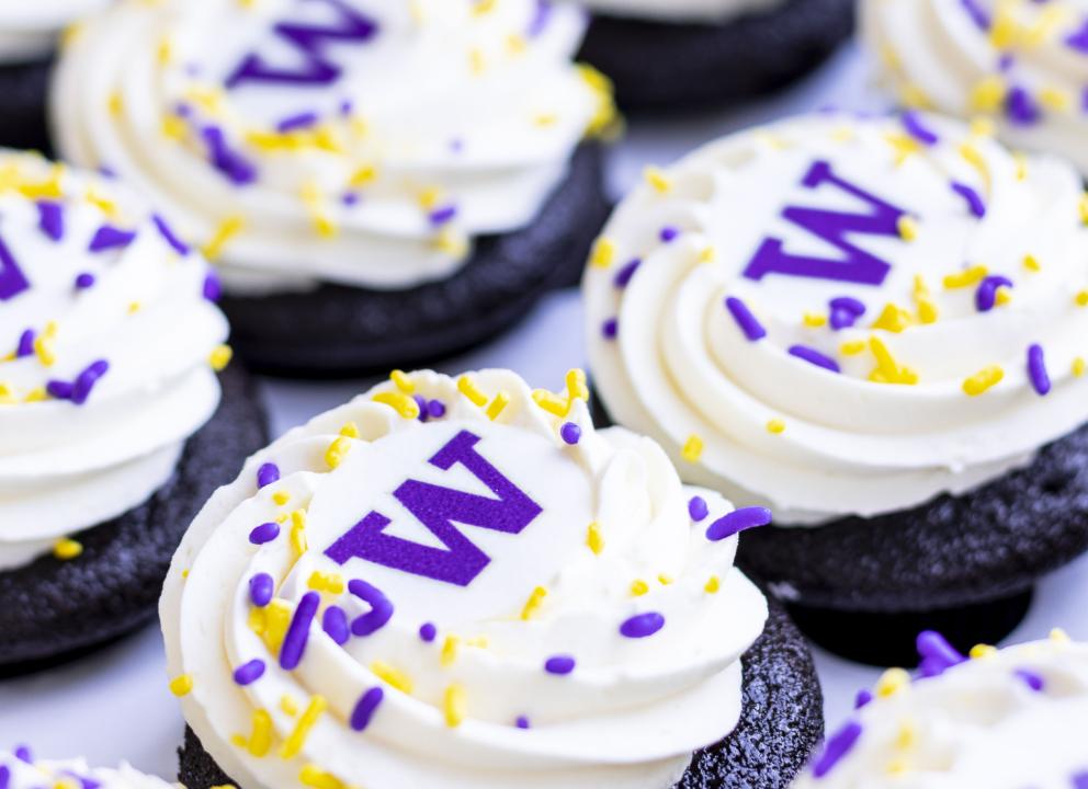cupcakes with white frosting, sprinkles and a W